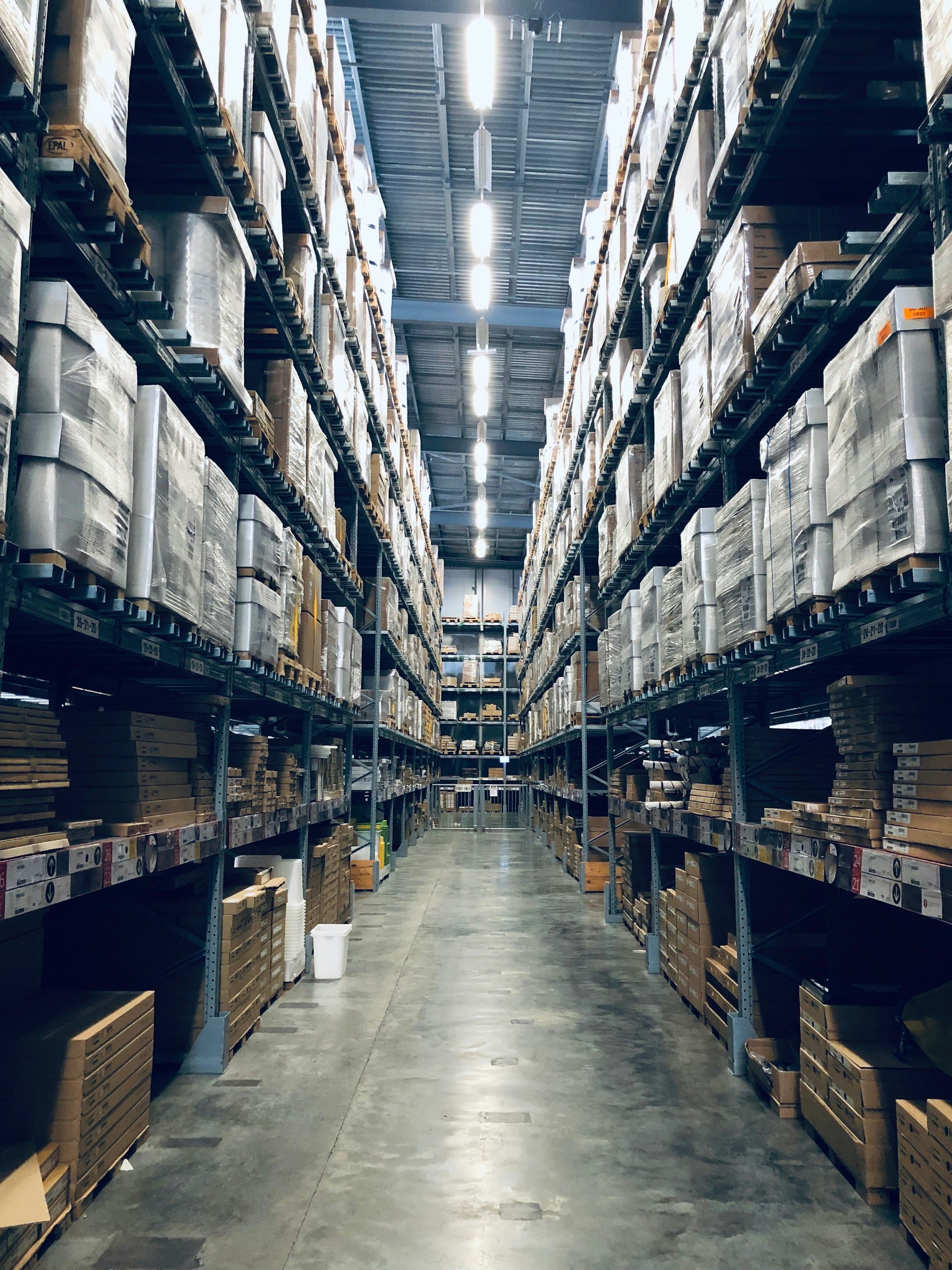 Long warehouse aisles stacked high with boxed goods